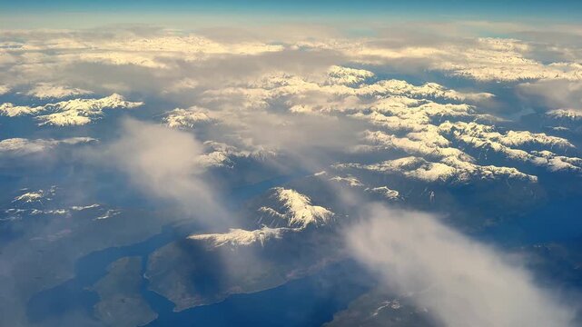 Sunbeams shining through clouds over a mountainous landscape