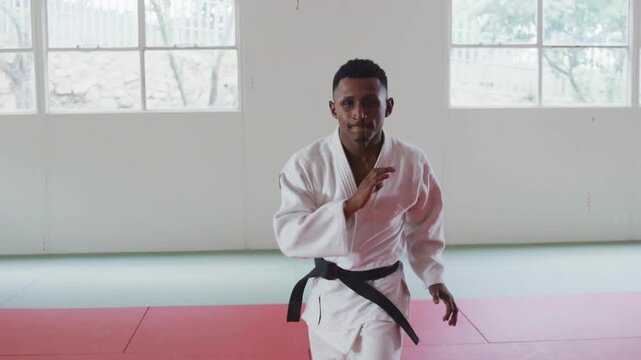 Martial artist shifting stepping spinning kick training in gi with red overlays appearing