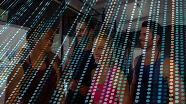Chatting group in arc in studio, wearing pink blue tanks, holding phone behind beaded curtain
