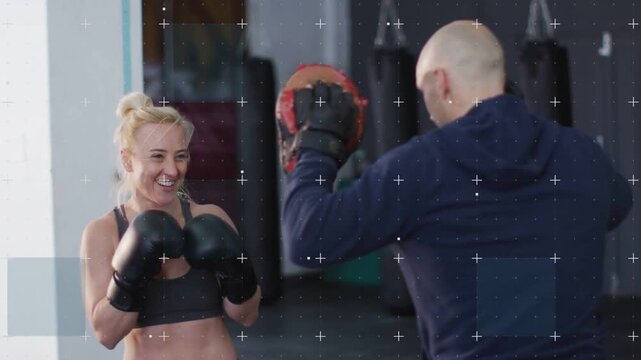 Woman trainee throwing jabs, slipping under pads after coach holding pads, training timing, defense