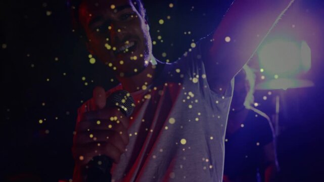 Cue starting, singer adjusting mic and performing, leaning in, backlight shadow, gold dust floating