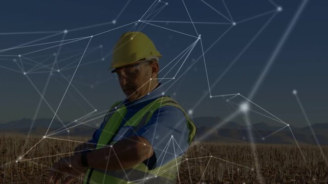 Field tech entering frame, checking wrist device while network visualizing turbine performance