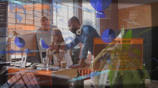 Diverse coworkers leaning at office, pointing and triaging while malware alerts flashing onscreen