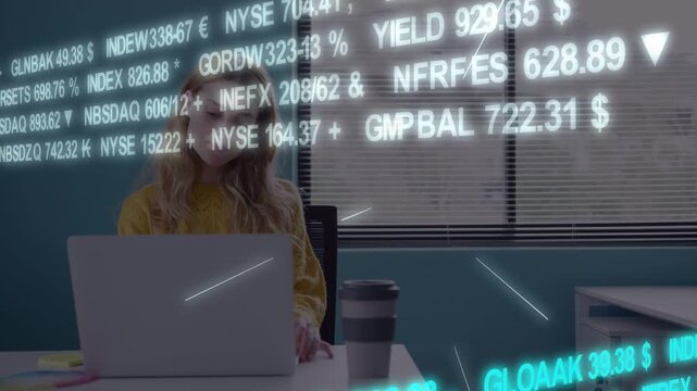 Woman typing at desk, causing finance tickers scrolling and partially obscuring laptop for analysis