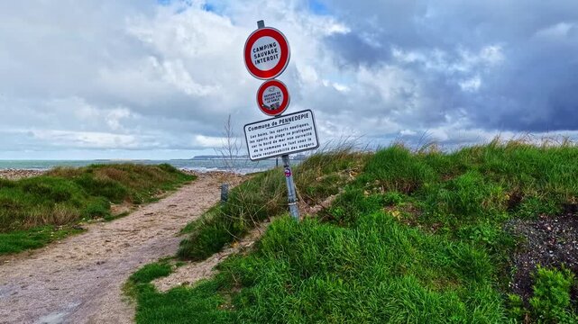 Le Havre industrial port view from Pennedepie beach with forbidden camping signs, France