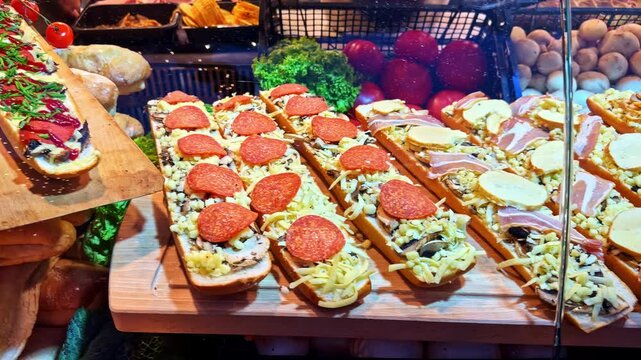 Traditional polish street food zapiekanka with various toppings on display at a market stall in Krakow, Poland