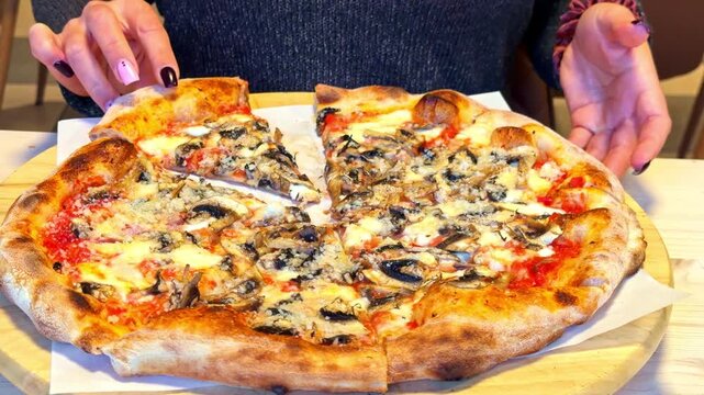Delicious mushroom pizza being served on a wooden table with excitement