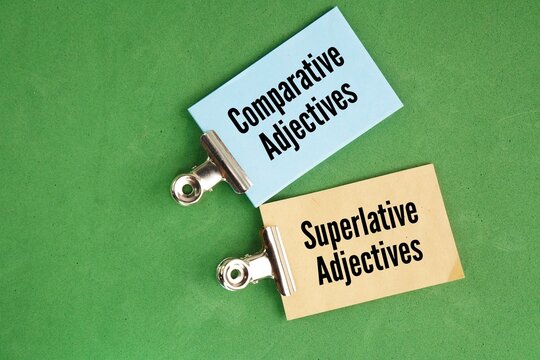 Paper with the words comparative adjectives and superlative adjectives. Comparative adjectives compare two items, while superlative adjectives compare three or more
