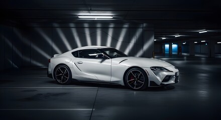 Fototapeta premium A white Toyota Supra Mk5 displayed under dramatic lighting in an industrial setting, with beams of light creating an intense atmosphere. The car is highlighted, emphasizing its aggressive stance and s