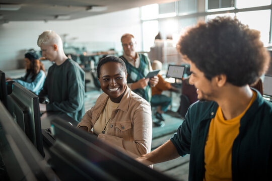 Students collaborating on computers in university lab