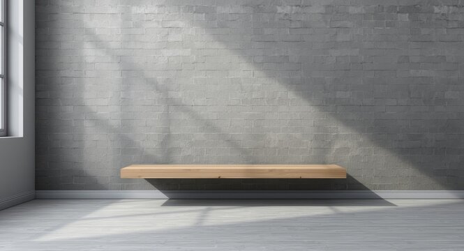 Unfilled wood shelf structure positioned in front of rough grey brick wall