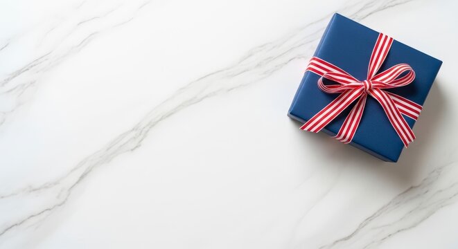 Gift box with red white blue ribbon.