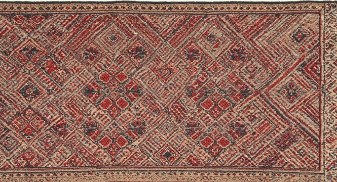 Top view of intricate ethnic weaving patterns on a handmade ulos textile showcasing traditional craftsmanship