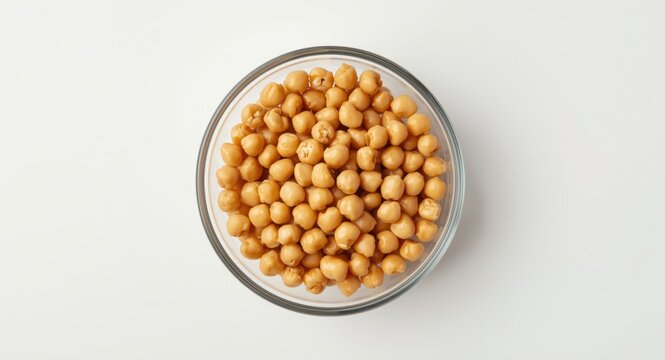 Healthy eating idea featuring organic chickpeas in a glass bowl on a plain surface
