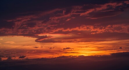 Fototapeta premium Sunset horizon glowing with intense cloud colors and copy space