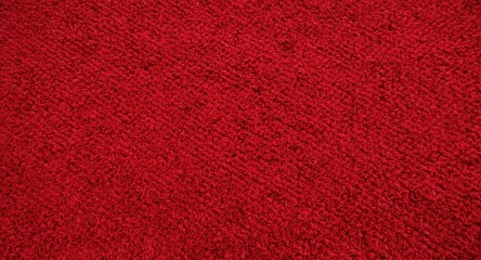 Fototapeta premium Vivid red textured carpet with soft daylight background