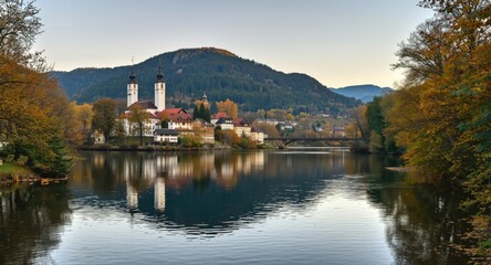 Obraz premium Tranquil river and monastery scene showcasing autumn transformation