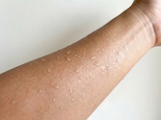 Fototapeta premium Closeup of a sweaty arm on a white background