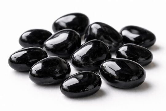 Set of polished Apache Tear obsidian stones displayed on a clean white background