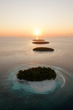 Aerial view of small islands in the Indian Ocean at sunrise, Maldives