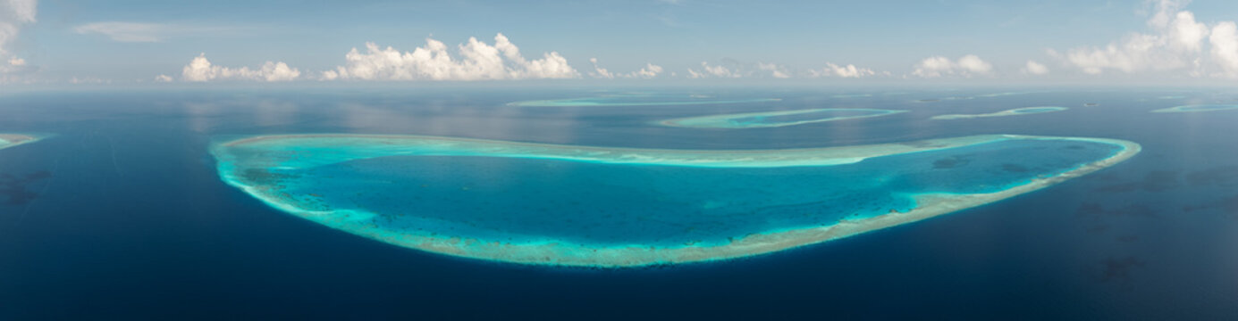 Aerial panoramic view of ring shaped atoll in the ocean, Maldives