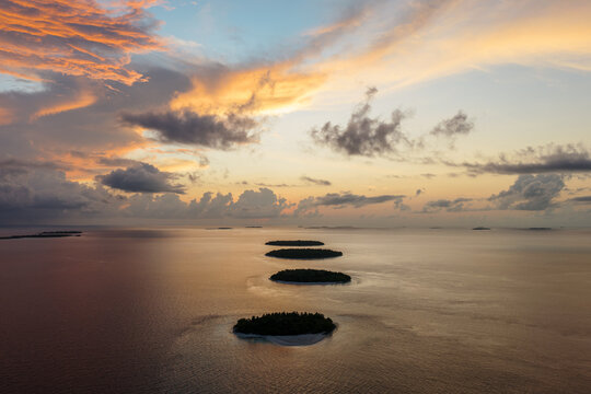 Aerial view of small islands in the Indian Ocean at sunset, Maldives