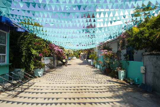 Street with flags and flowers on a local island in the Maldives