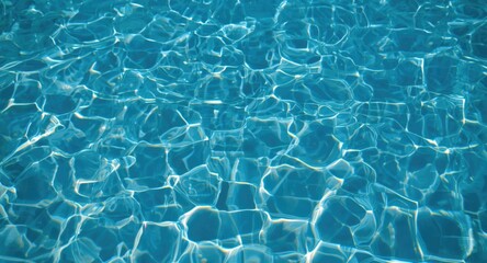 Obraz premium Sparkling aqua water in swimming pool with pebbled ground and light reflected ripples
