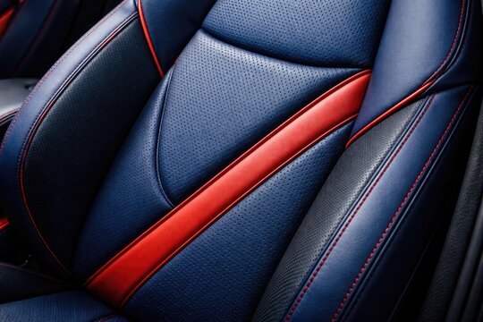 Close up view of synthetic rubber and leather car seat cover in blue with red accents