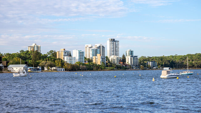 Riverside skyline with moored boats across Swan River from Matilda Bay Reserve, Perth, Australia, 2 February 2022