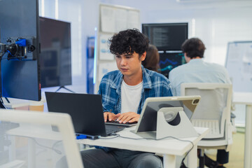 Fototapeta premium Asian AI agent programmer analyzing complex data at a multi-monitor workstation, developing autonomous business workflows and discussing agentic trends for modern enterprise automation.