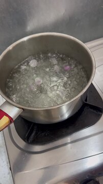 Boiling Water with Sliced Shallots  for Spinach Soup Stock