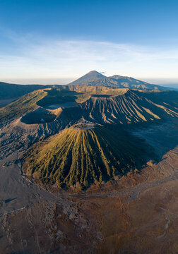 Majestic Volcanic Landscape: An awe-inspiring aerial perspective of a volcanic caldera under a clear blue sky, revealing the raw power and beauty of nature's geological artistry.