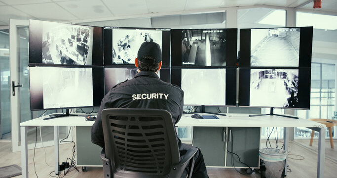 Man, security guard and monitor in control room for safety, back or display for video analysis job. Person, surveillance officer and footage for review, computer or screen for crime prevention career