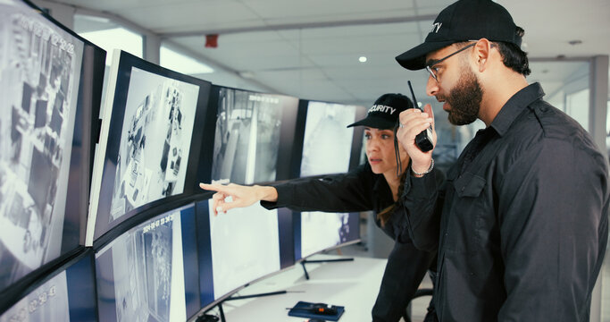 Security, control room and people with radio by monitor for communication, surveillance or report. Safety officer, computer screen and team point or talk about property breach, inspection or dispatch