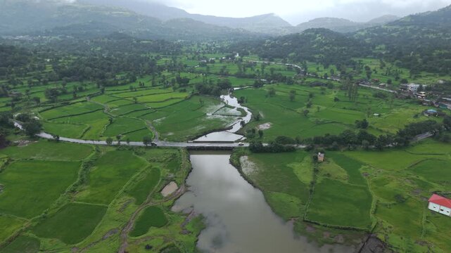 Aerial Drone View of Bhandardara Landscape with Green Valley River and Monsoon Clouds Maharashtra India