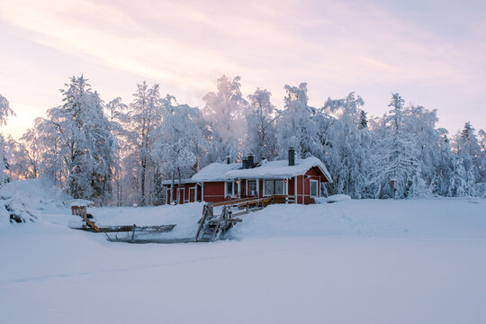 Snow-covered cabin in Akaslompolo Village, a winter wonderland in Lapland, Finland