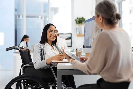 Mentor, wheelchair and women with tech at inclusive office for writing, training or research at desk. Communication, tablet and happy person with a disability, equality and accessibility at workplace