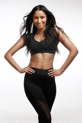 Fototapeta premium Smile, fitness and woman in studio with confidence, body care and wellness with personal trainer. Portrait, athlete and person with pride, workout coach and exercise instructor on white background