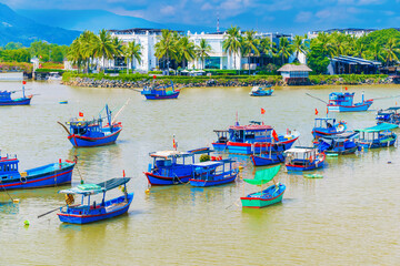 Traditional Vietnamese wooden fishing boats on Cai River in the port. View of the Cai River in Nha Trang in Vietnam