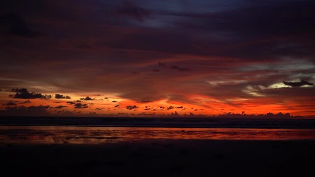 Dark Moody Red Sunset Sky over Ocean at Pantai Kelating Beach Bali