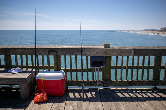 Two Fishing Poles and Cooler on Pier on Beach in Tybee Island, Georgia