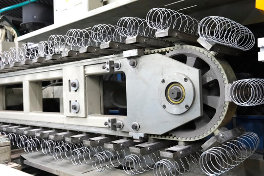 Production of springs for mattresses at factory on the machine.