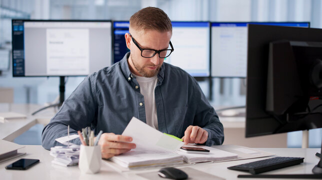 Fraud Analyst Diligently Examining Multiple Monitors