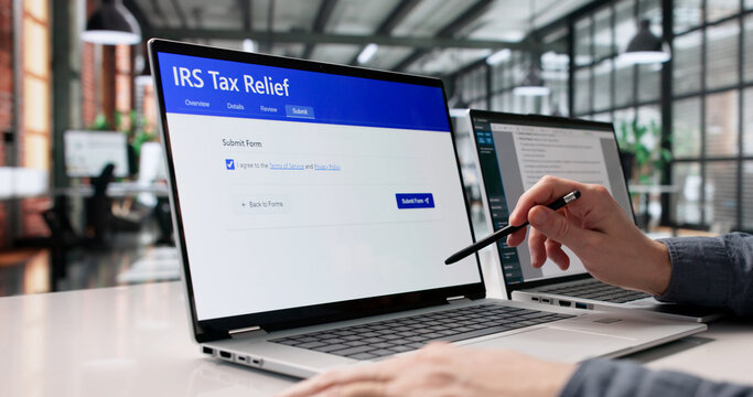 Young Man Completing IRS Tax Relief Application Digitally