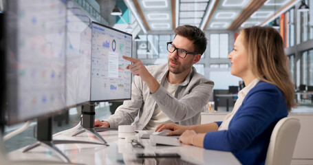 Compliance Specialist Analyzes Risk Analytics On Desktop For Regulatory Audit