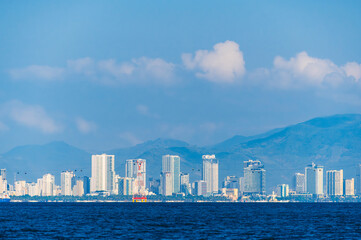 Panorama of Nha Trang city in Vietnam. Resort town with skyscrapers of hotels by the sea in Asia on summer day