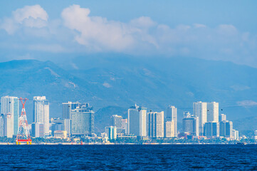 Panorama of Nha Trang city in Vietnam. A resort town with skyscrapers of hotels by sea in Asia on a summer day