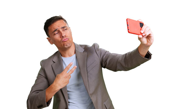 Young man making duck face with smartphone taking selfie