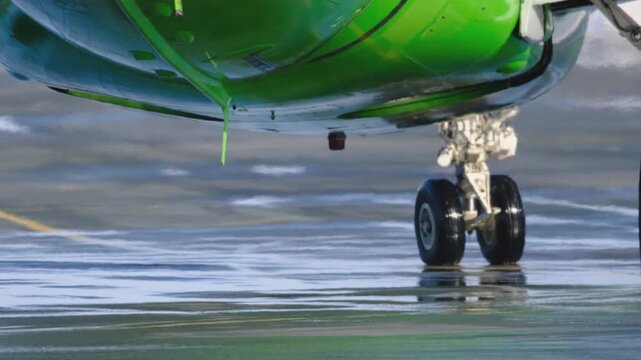 Airplane landing gear runway. Airport terminal maintenance crew aircraft. Preparing for departure takeoff. Safety. Close-up of airplane's wheels before takeoff.